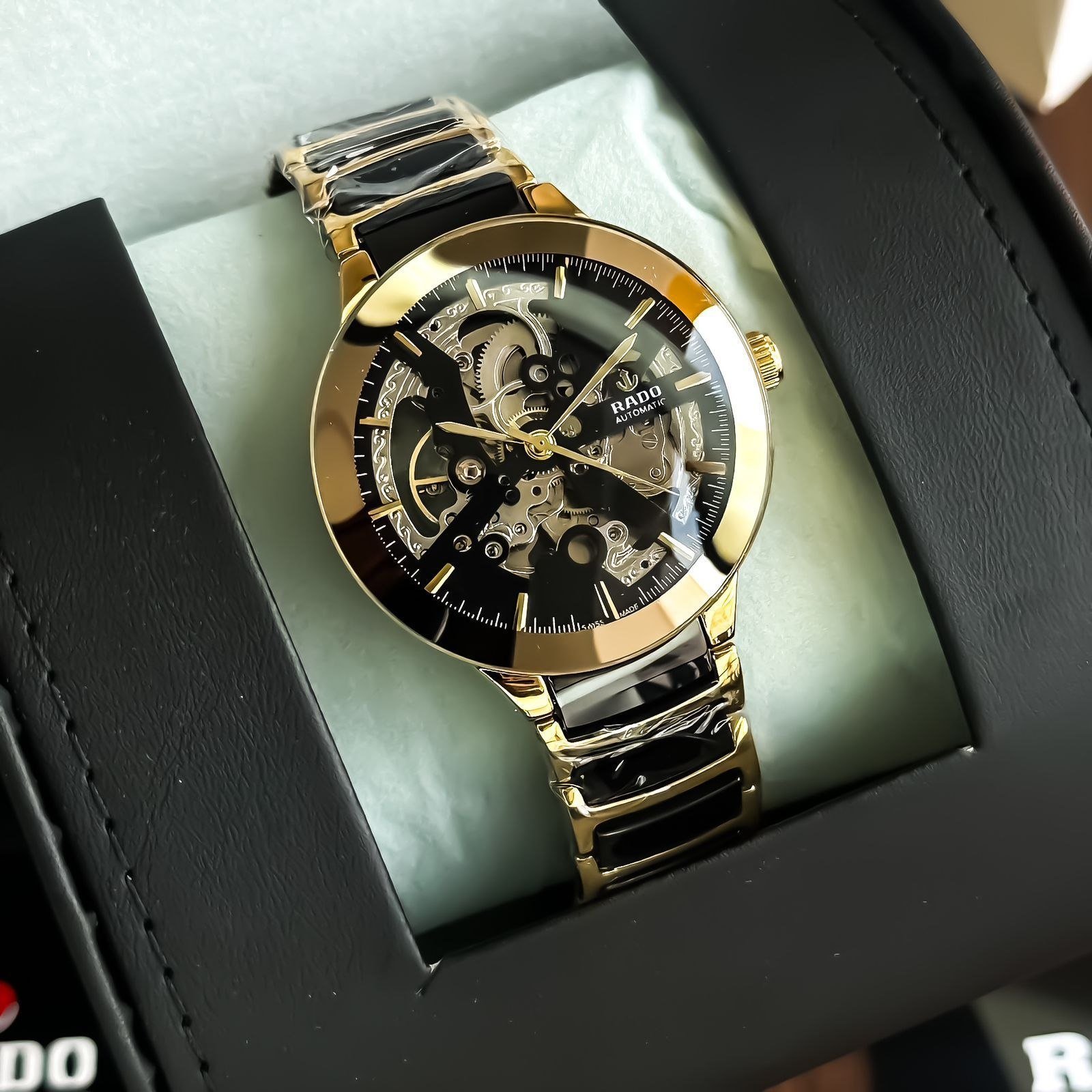 Rado Centrix / True Automatic Skeleton (Gold and Black Edition) — Gold-Plated Stainless Steel Case with Full Skeleton Dial, Open-Heart Movement, and Gold & Black Link Bracelet